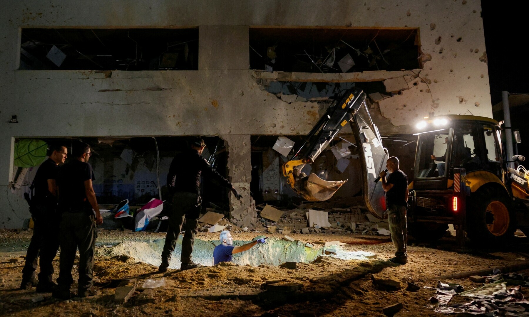  Israeli rescue force members inspect the site where a missile fired from Iran towards Israel hit a school building, in central Israel, on Oct 1, 2024. &mdash; Reuters 