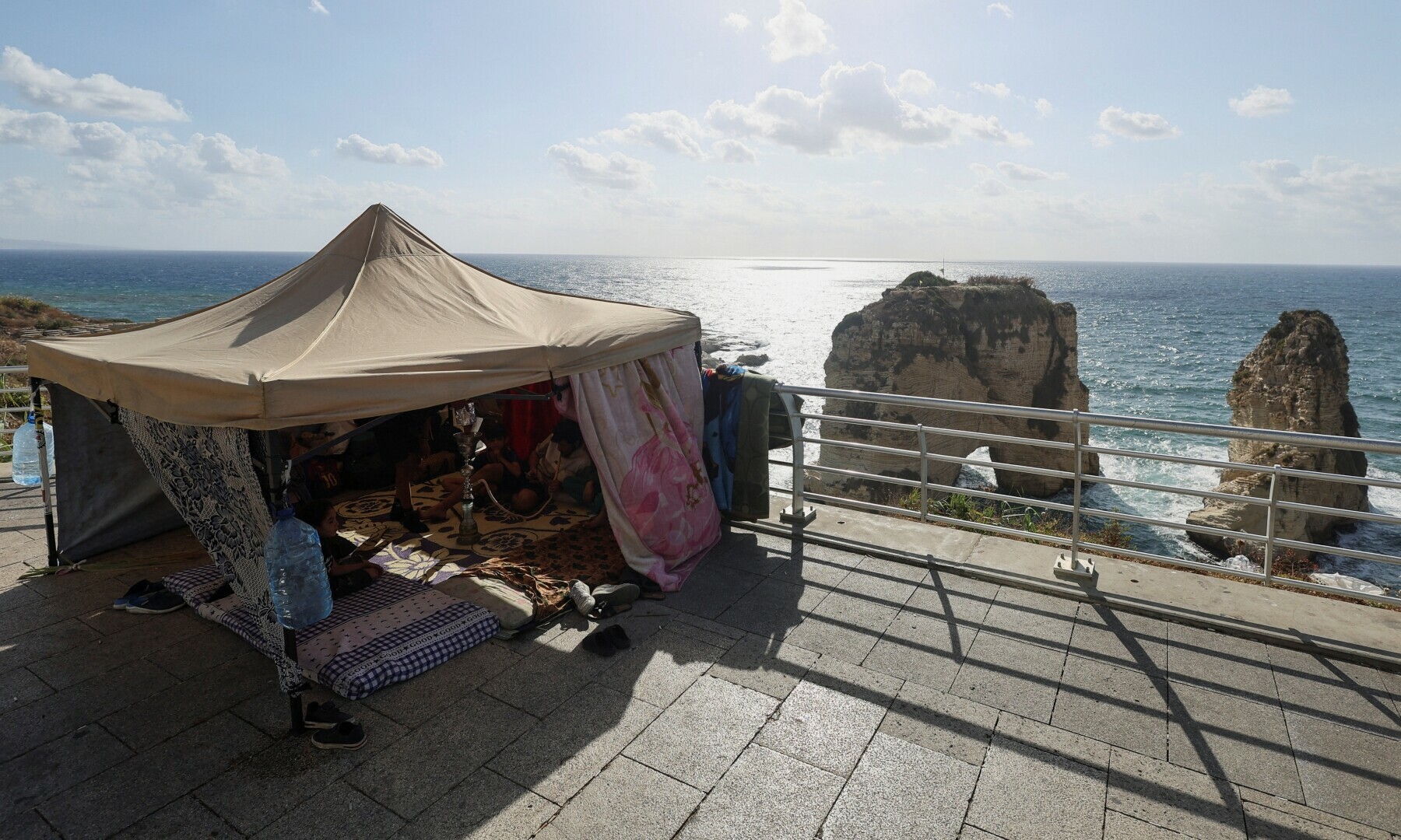  A displaced Syrian family sits in a makeshift tent as they seek refuge along the city&rsquo;s corniche after their family home in Beirut&rsquo;s southern suburb of Dahiyeh was damaged by an Israeli airstrike, in Lebanon on Oct 1, 2024. &mdash; Reuters 