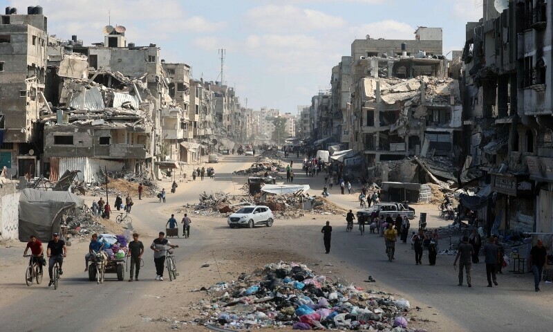 Palestinians carry their belongings as they flee areas north of Gaza City in the northern Gaza Strip on October 12. &mdash; AFP