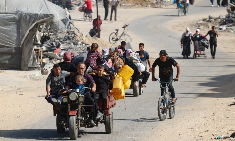 Palestinians transport their belongings as they flee areas north of Gaza City in the northern Gaza Strip on October 12. &mdash; AFP