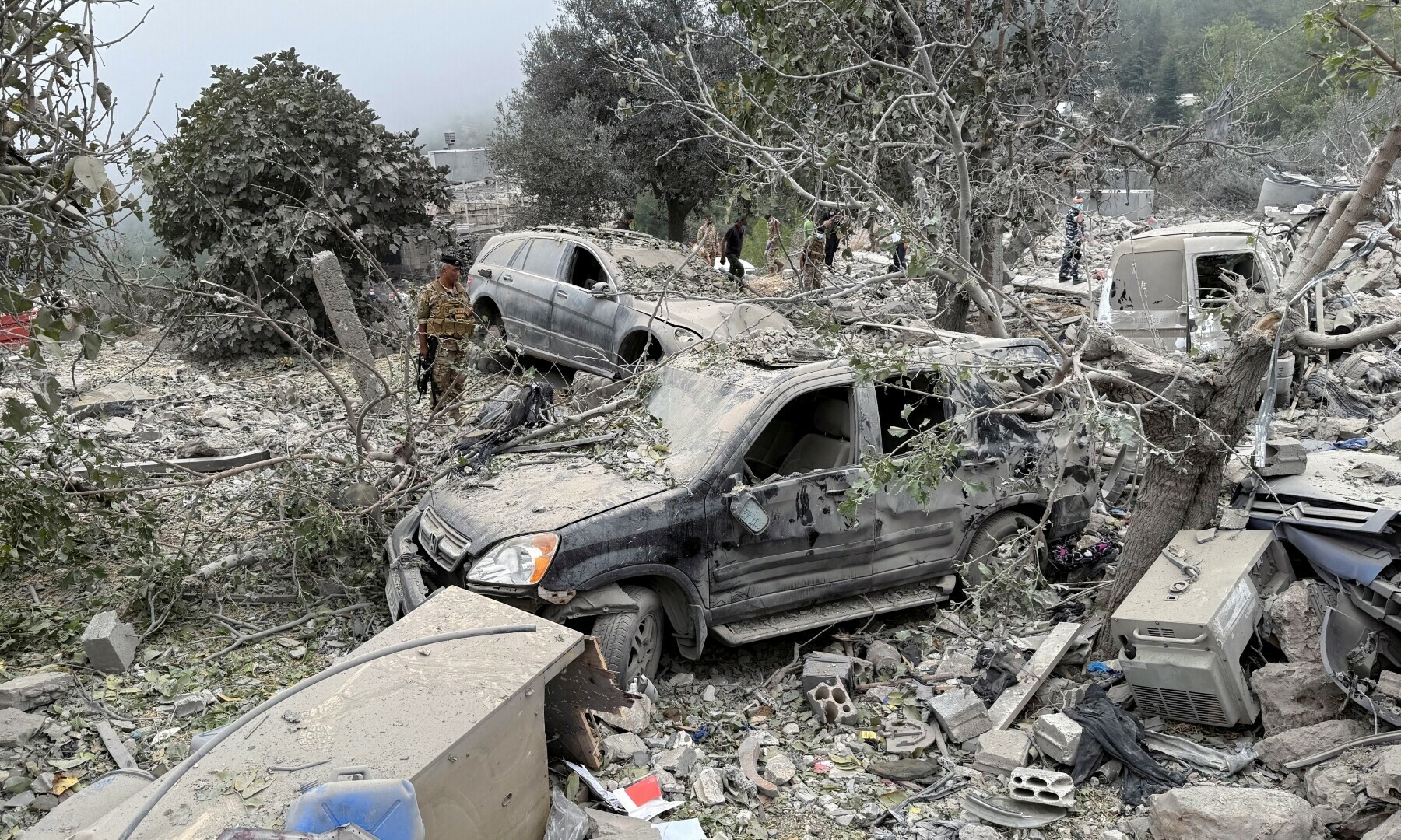 Lebanese army soldier stands near destroyed vehicles at a site damaged by an Israeli air strike in the Christian-majority region of Aitou in north Lebanon, on Oct 14, 2024. — Reuters