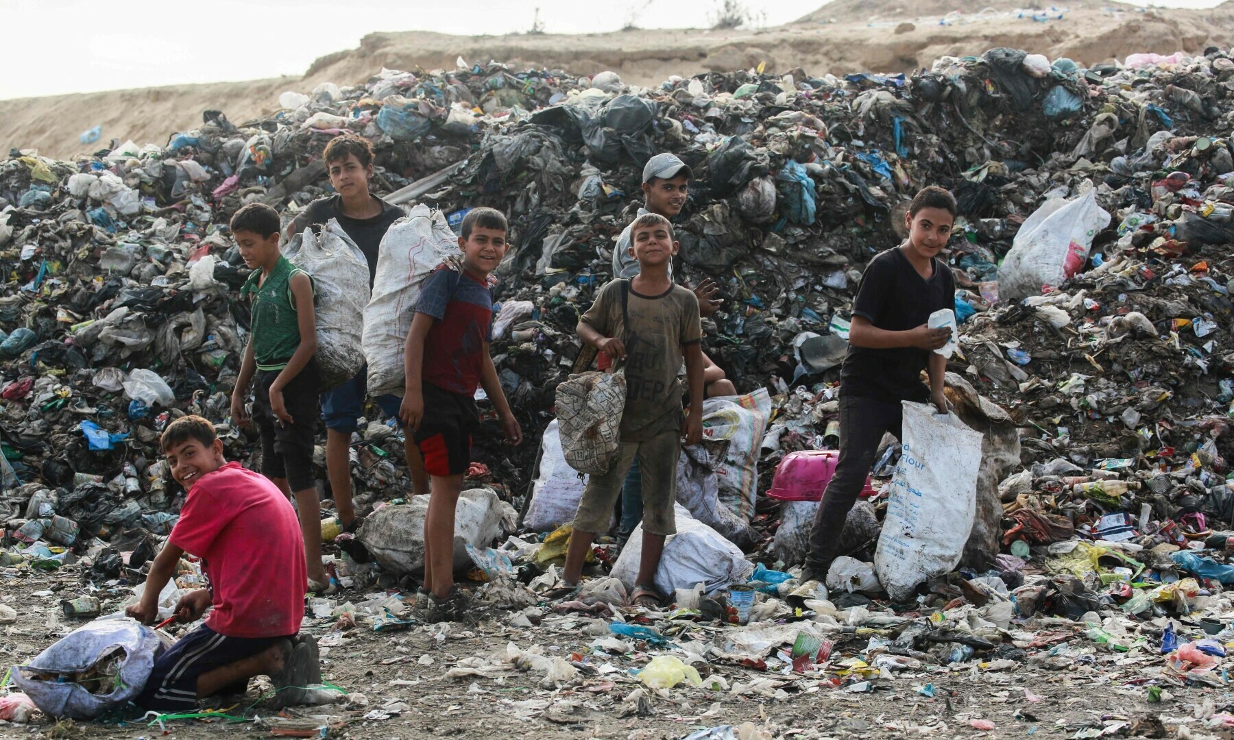  Children sift through waste at a landfill in Khan Younis in the southern Gaza Strip on Oct 15, 2024. &mdash; AFP 