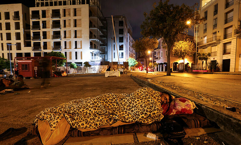 A displaced man sleeps on the street in Beirut’s central Martyrs’ Square on October 30. — Reuters