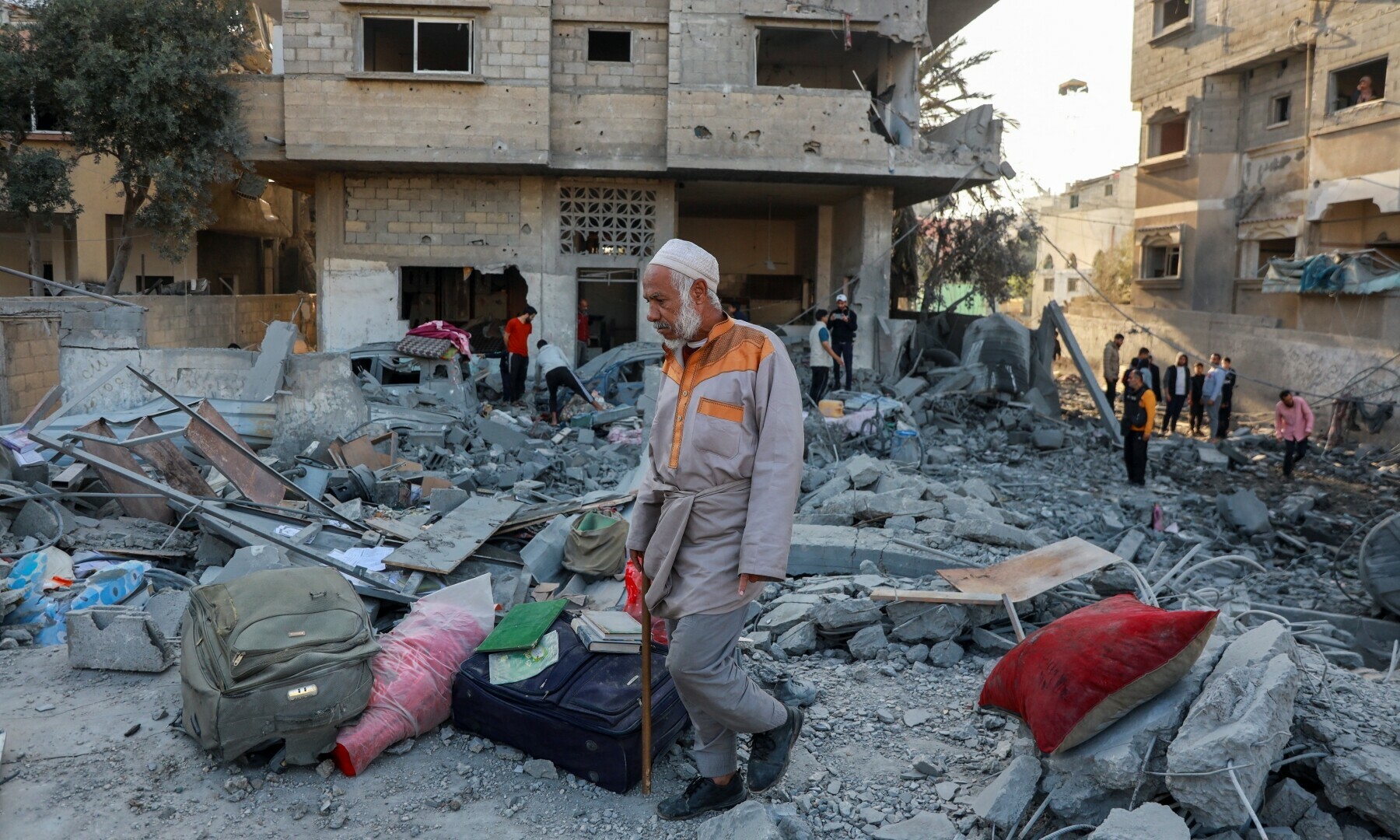 A Palestinian man walks through the rubble at the site of an Israeli strike on a house, amid the Israeli bombardment of Gaza, in Nuseirat in the central Gaza Strip on November 7. &mdash; Reuters