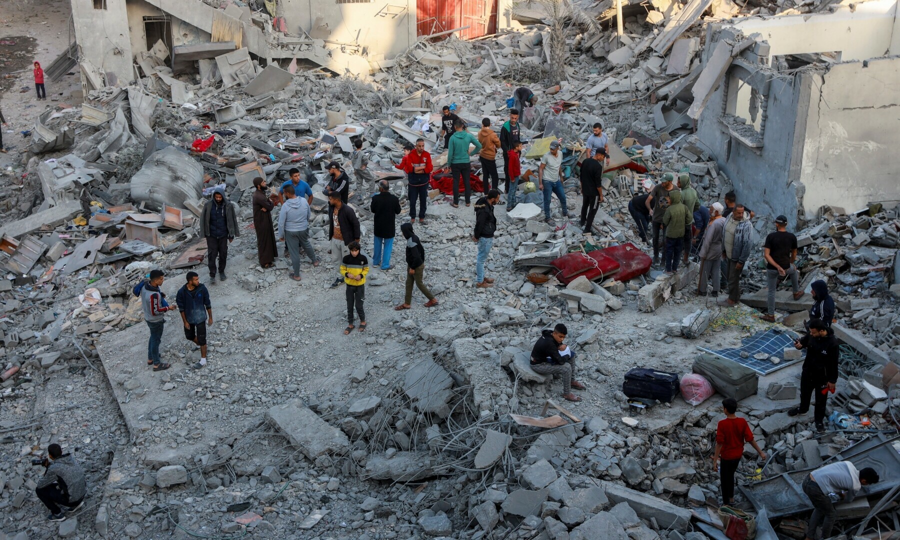 Palestinians gather at the site of an Israeli strike on a house, amid the Israeli bombardment of Gaza, in Nuseirat in the central Gaza Strip on November 7. &mdash; Reuters