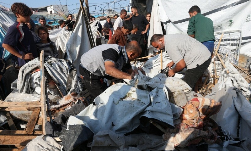 Palestinians inspect the site of an Israeli strike on a tent housing displaced people, at Al-Aqsa Martyrs Hospital in Deir Al-Balah, in the central Gaza Strip on November 9. &mdash; Reuters