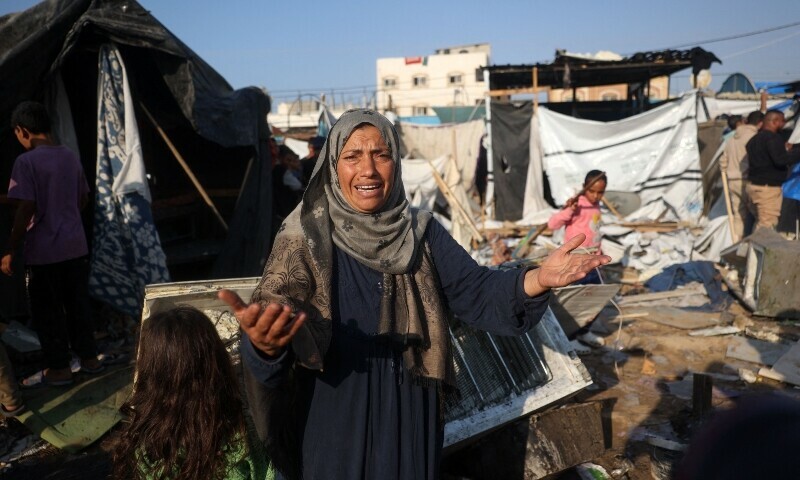 A woman reacts as displaced Palestinians check the damage following an Israeli strike that hit tents set up in the vicinity of the Al-Aqsa Martyrs hospital in Deir el-Balah in the central Gaza Strip on November 9. &mdash; AFP
