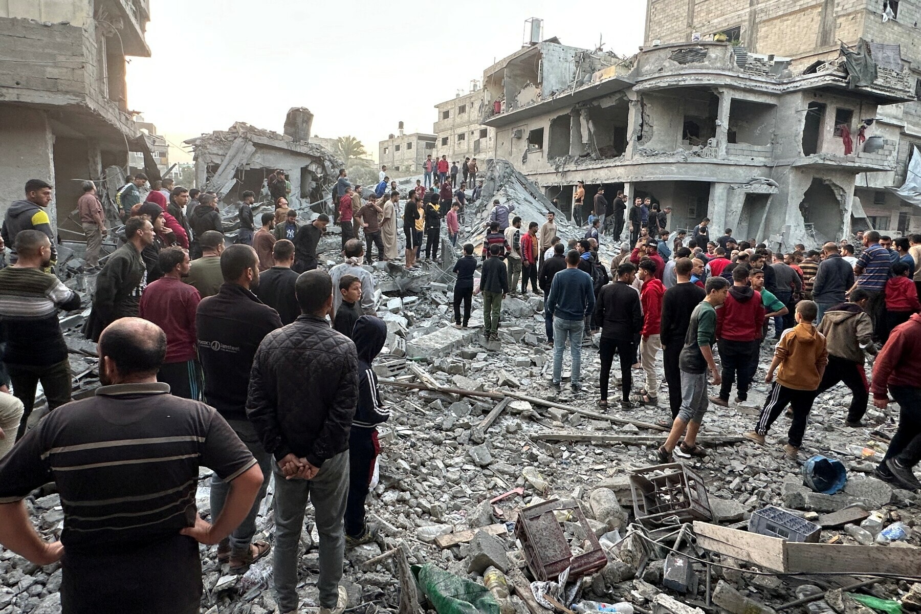 Palestinians gather at the site of an Israeli strike on a house, in Jabalia in the northern Gaza Strip on November 10. &mdash; Reuters
