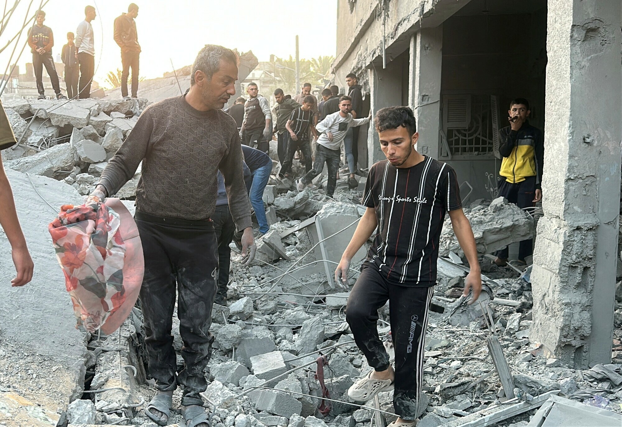 Palestinians gather at the site of an Israeli strike on a house, in Jabalia in the northern Gaza Strip on November 10. &mdash; Reuters