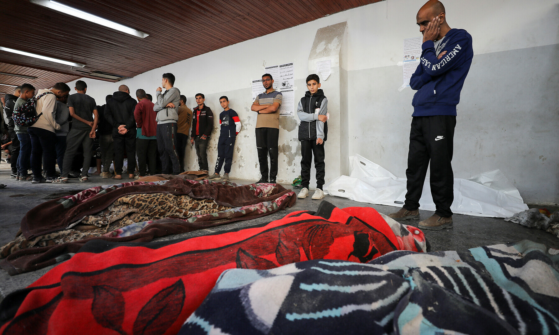 Mourners gather next to the bodies of Palestinians killed in an Israeli strike on a house in Jabalia on November 10. &mdash; Reuters