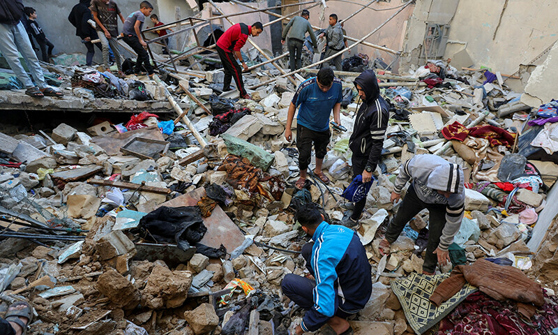 Palestinians inspect the site of an Israeli strike on a house in Nuseirat in the central Gaza Strip on November 13.&mdash; Reuters