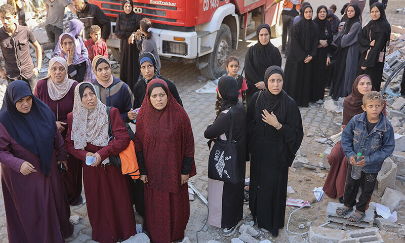 Women react near the rubble of a house destroyed in an Israeli strike as rescuers search for casualties on al-Jalaa street in central Gaza City on November 18. &mdash; AFP