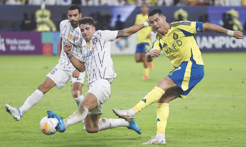 RIYADH: Al Nassr’s Cristiano Ronaldo (R) in action with Fabio Cardoso of Al Ain during their Asian Champions League Group ‘B’ match at Al Awwal Park.—Reuters RIYADH: Al Nassr’s Cristiano Ronaldo (R) in action with Fabio Cardoso of Al Ain during their Asian Champions League Group ‘B’ match at Al Awwal Park.—Reuters