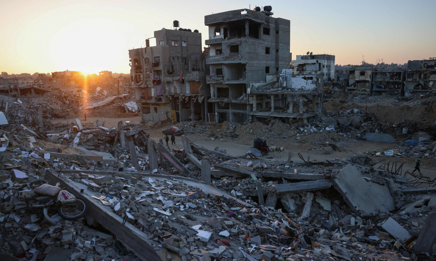 Palestinians walk in a devastated neighbourhood due to Israeli strikes in the southern Gaza Strip on Dec 2, 2024. — AFP