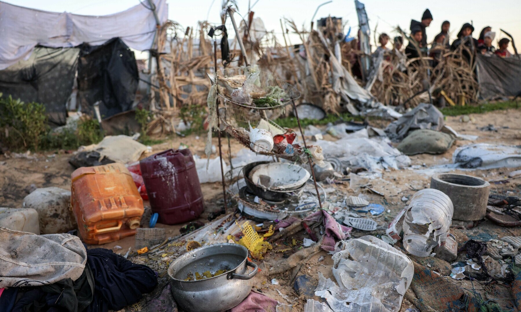  Destroyed water containers and discarded cooking pots and utensils are strewn across the scene at the site of reported Israeli bombardment on tents sheltering Palestinians displaced from Beit Lahia at a camp in Khan Younis in the southern Gaza Strip on Dec 25, 2024. &mdash; AFP 