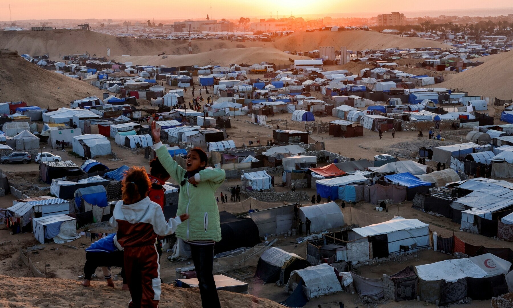 Displaced Palestinian children talk to each other as they shelter in a tent camp in Khan Younis, southern Gaza Strip on Dec 29, 2024. — Reuters