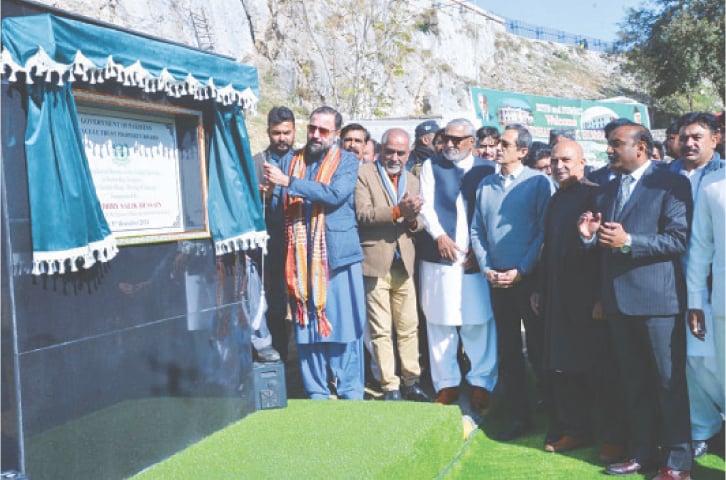 Federal Minister for Religious Affairs and Interfaith Harmony Chaudhry Salik Hussain unveils the plaque of the project at Katas Raj in Chakwal on Thursday. &mdash; Dawn