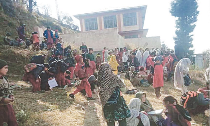 Students sit outside the locked school in Chakesar tehsil of Shangla. &mdash; Dawn