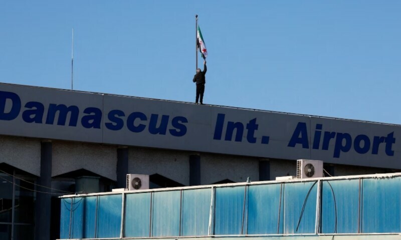 A worker adjusts the flag adopted by the new Syrian rulers on the day the first domestic flight departs from Damascus International Airport to Aleppo International Airport during the re-opening of the airport after the ousting of Syria’s Bashar al-Assad, in Damascus, Syria, Dec 18. — Reuters A worker adjusts the flag adopted by the new Syrian rulers on the day the first domestic flight departs from Damascus International Airport to Aleppo International Airport during the re-opening of the airport after the ousting of Syria’s Bashar al-Assad, in Damascus, Syria, Dec 18. — Reuters