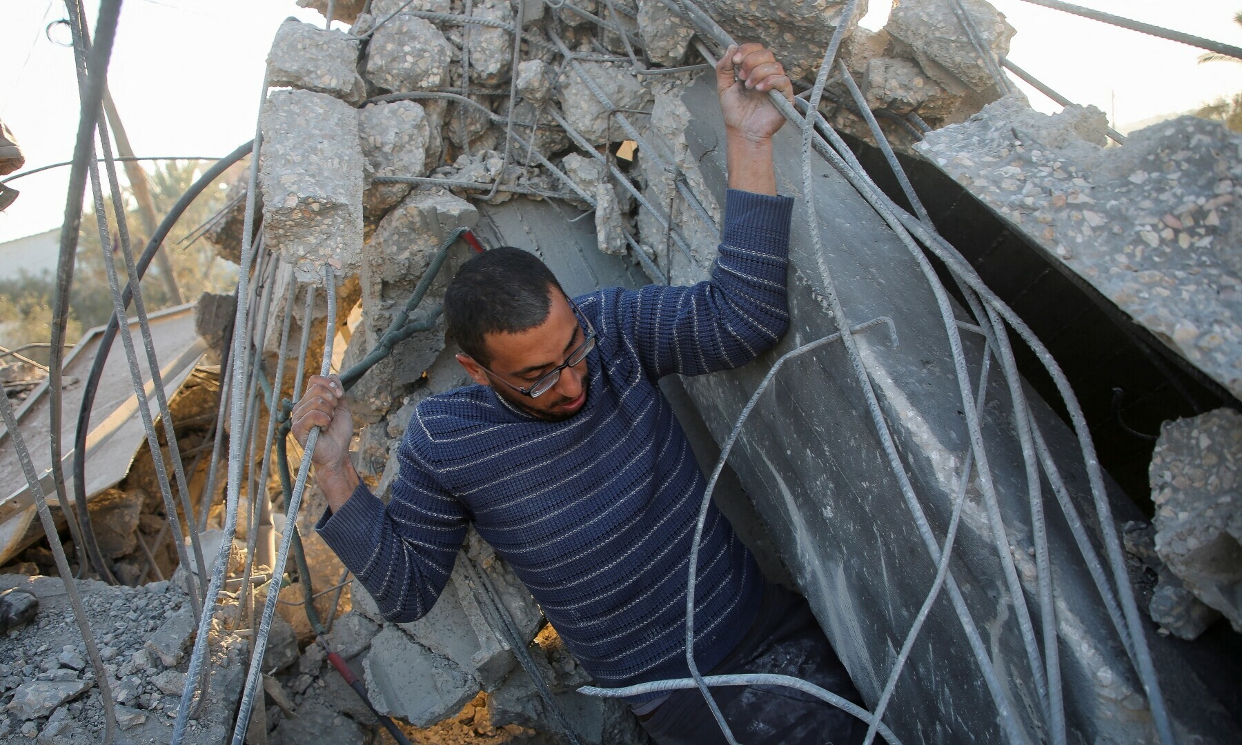 A Palestinian man inspects the site of an Israeli strike on a house, in Khan Younis in the southern Gaza Strip, on Jan 14, 2025. Reuters/Hatem Khaled