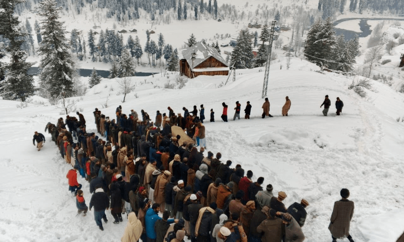 People gather to offer the funeral prayers of a 21 years old pregnant woman in Taobutt Bala village of Neelum valley on Sunday. The woman died on Saturday night when she was being carried to a health facility on foot. &mdash; Photo by author