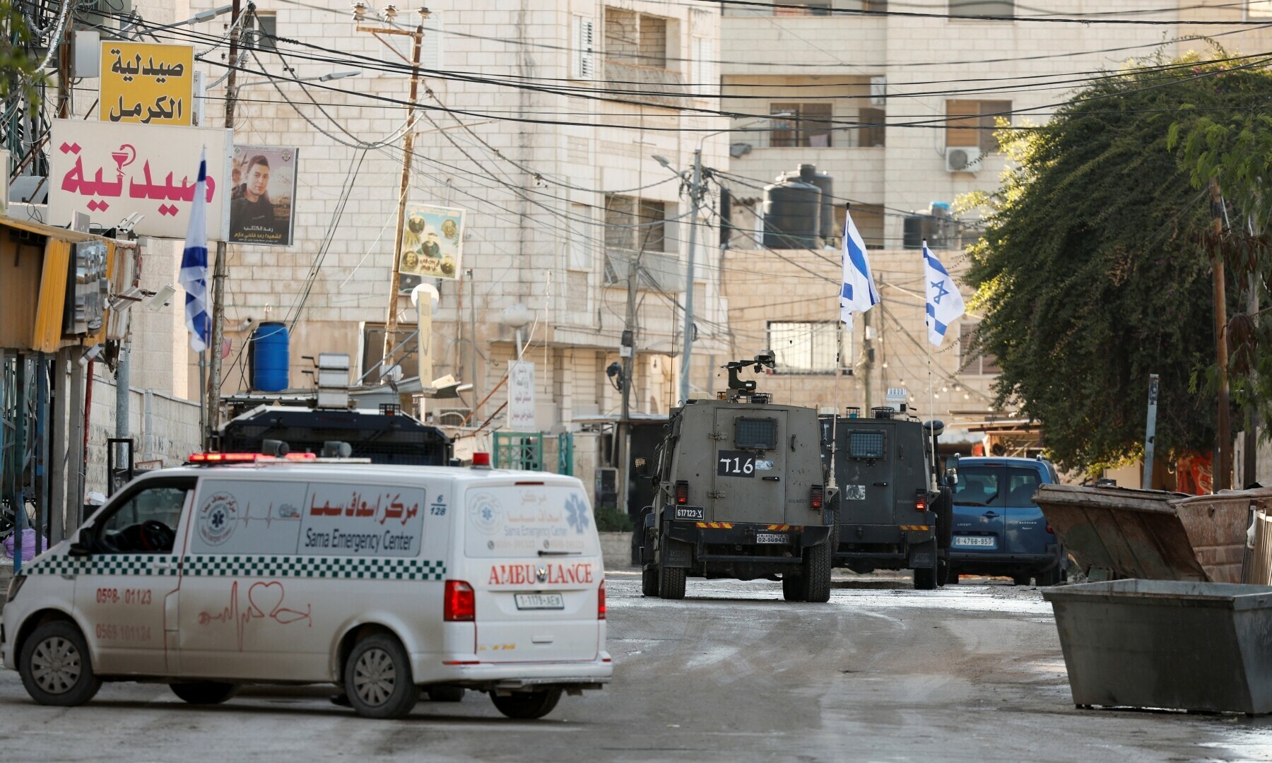  Israeli military vehicles drive on the street during an Israeli raid, in Jenin, in the Israeli-occupied West Bank on January 21. &mdash; Reuters/Raneen Sawafta 