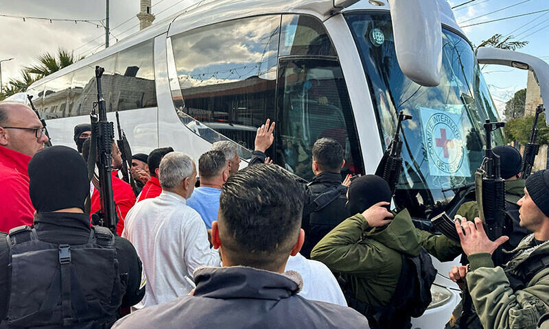 People gather near a bus carrying freed Palestinian prisoners after they were released from an Israeli jail as part of a hostages-prisoners swap and a ceasefire deal in Gaza between Hamas and Israel, in Ramallah, in the Israeli-occupied West Bank on January 25. — Reuters