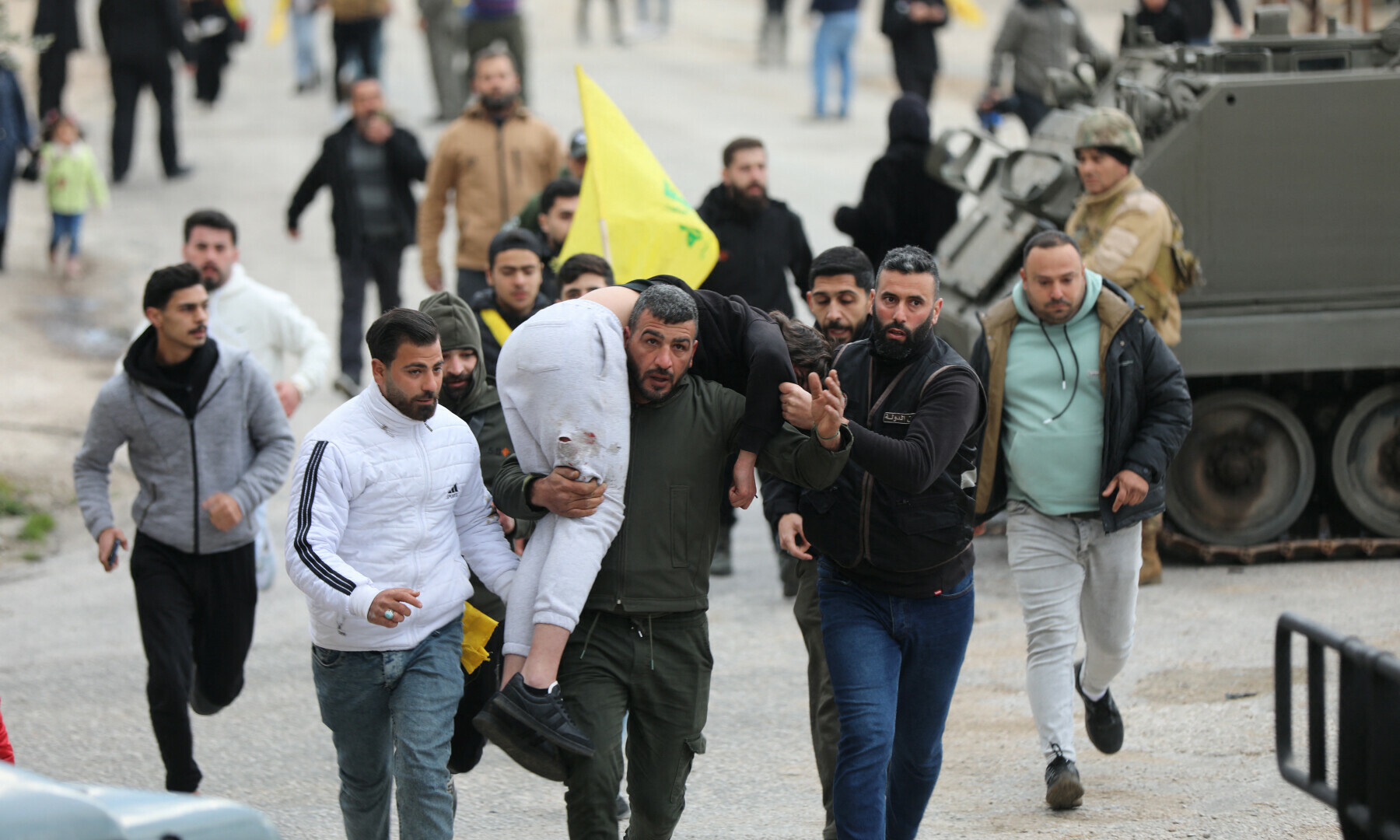  A man carries an injured person in Burj al-Muluk, near the southern Lebanese village of Kfar Kila, where Israeli forces remained on the ground after a deadline for their withdrawal passed as residents sought to return to homes in the border area, Lebanon on January 26. &mdash; Reuters/Karamallah Daher 