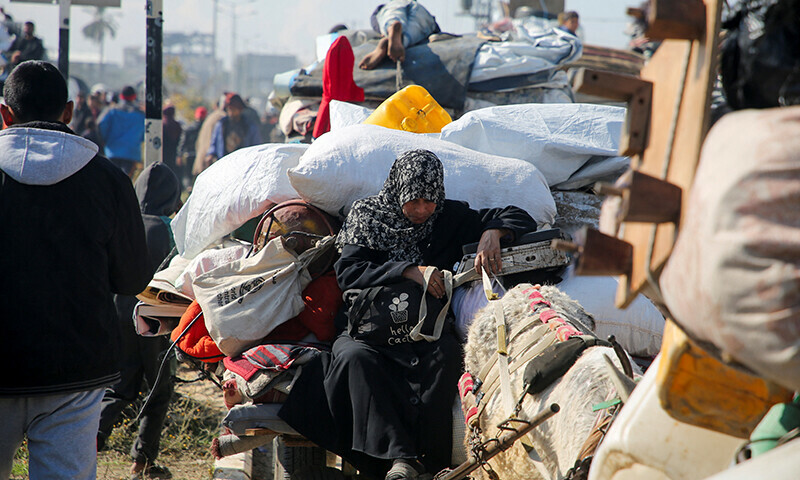 A woman sits as Palestinians, who were displaced to the south at Israel’s order during the war, wait to head back to their homes in northern Gaza by vehicle through Salahudeen Road, amid a ceasefire between Israel and Hamas, in the central Gaza Strip on January 27. — Reuters