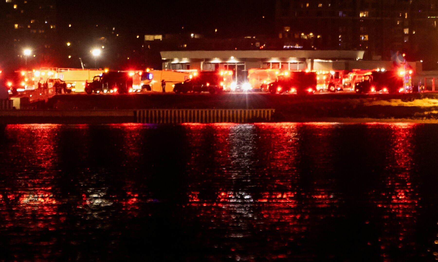 Emergency service vehicles operate near the site of the crash after American Eagle flight 5342 collided with a helicopter while approaching Ronald Reagan Washington National Airport and crashed in the Potomac River, outside Washington, US on January 29. — Reuters/Carlos Barria