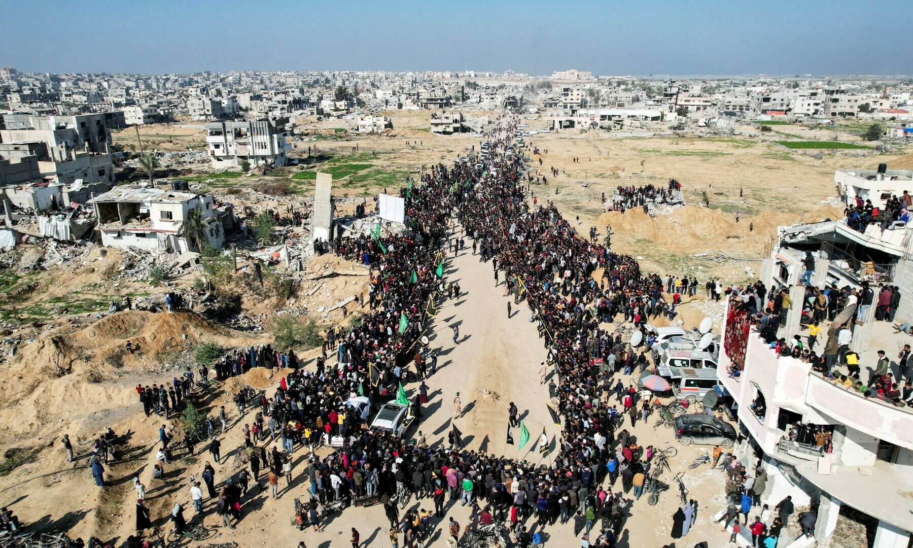 A drone view shows Palestinians gathering, on the day Palestinian fighters hand over hostages held in Gaza since Oct 7, 2023 attack to members of the ICRC, in Khan Younis in the southern Gaza Strip, on January 30. — Reuters