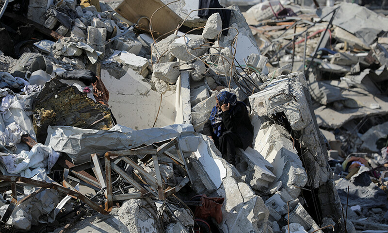  A Palestinian woman sits on the rubble of houses and buildings destroyed during the Israeli invasion, amid a ceasefire between Israel and Hamas, in Jabalia refugee camp in the northern Gaza Strip on January 29. &mdash; Reuters 