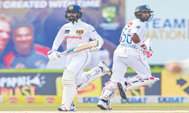 SRI LANKAN captain Dhananjaya de Silva (L) and team-mate Dinesh Chandimal run between the wickets during the first Test against Australia at the Galle International Stadium on Friday.&mdash;AFP