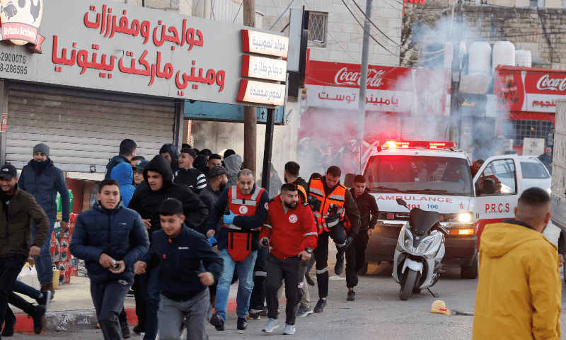 People stand near an ambulance, on the day prisoners are set to be released from an Israeli jail, near Ramallah in the Israeli-occupied West Bank on January 30. — Reuters/Raneen Sawafta