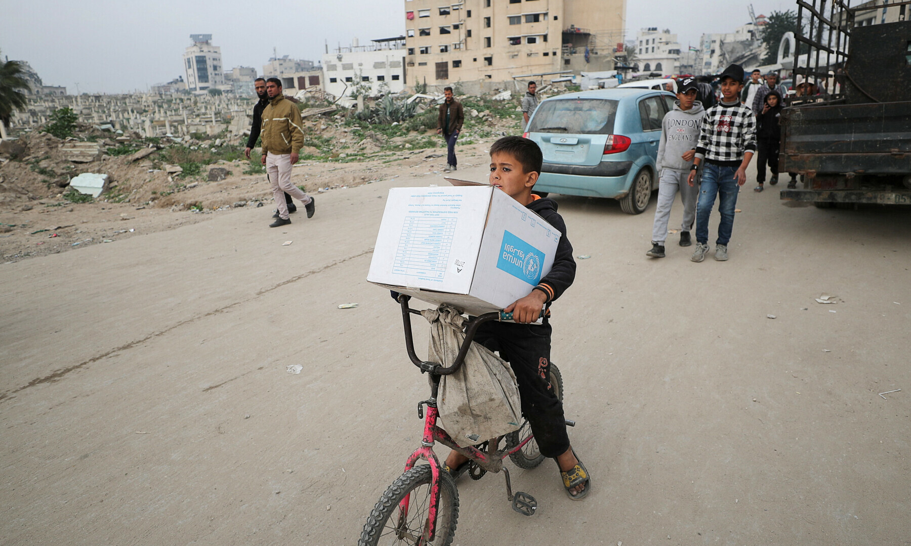  A Palestinian boy carries an aid box provided by UNRWA in Gaza City, on February 3, 2025. &mdash; Reuters/Dawoud Abu Alkas 
