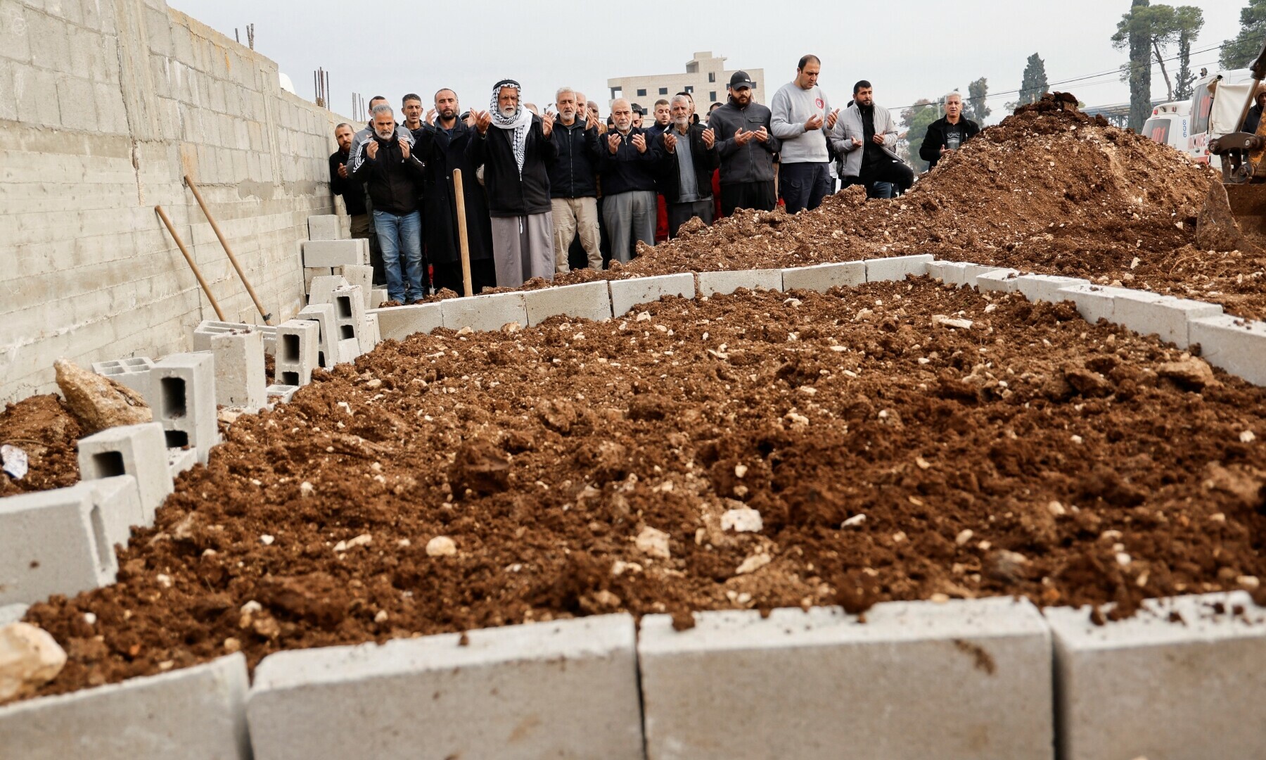  Mourners pray during the funeral of Palestinians killed in an Israeli raid, in Jenin, in the Israeli-occupied West Bank, February 3. &mdash; Reuters/Raneen Sawafta 