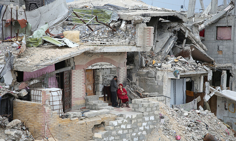 Palestinians gather outside a building destroyed during the Israeli offensive, amid a ceasefire between Israel and Hamas, in Khan Younis in the southern Gaza Strip on February 5. — Reuters