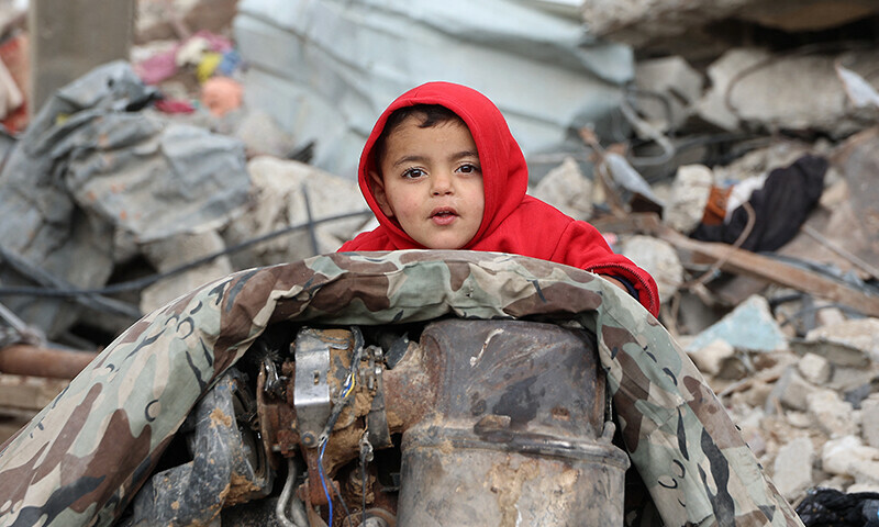 A Palestinian child sits amid the rubble of destroyed buildings at Saftawi street in Jabalia, in the northern Gaza Strip, on February 5 during a ceasefire in the Israeli invasion of Gaza. &mdash; AFP