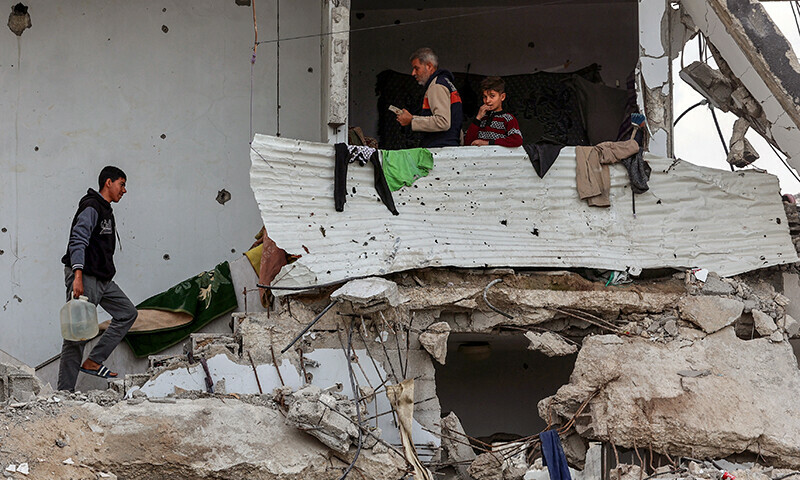 Palestinians take shelter in a heavily damaged building at Saftawi street in Jabalia, in the northern Gaza Strip, on February 5 during a ceasefire in the Israeli invasion of Gaza. &mdash; AFP