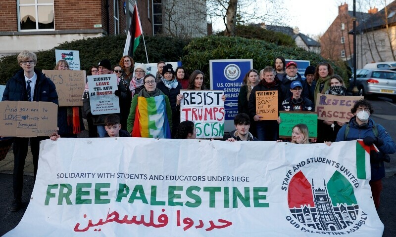 Demonstrators hold signs during a protest against US President Donald Trump, and the actions he has taken in the first weeks of his presidency, outside the US Consulate, in Belfast, Ireland, February 5, 2025. — Reuters