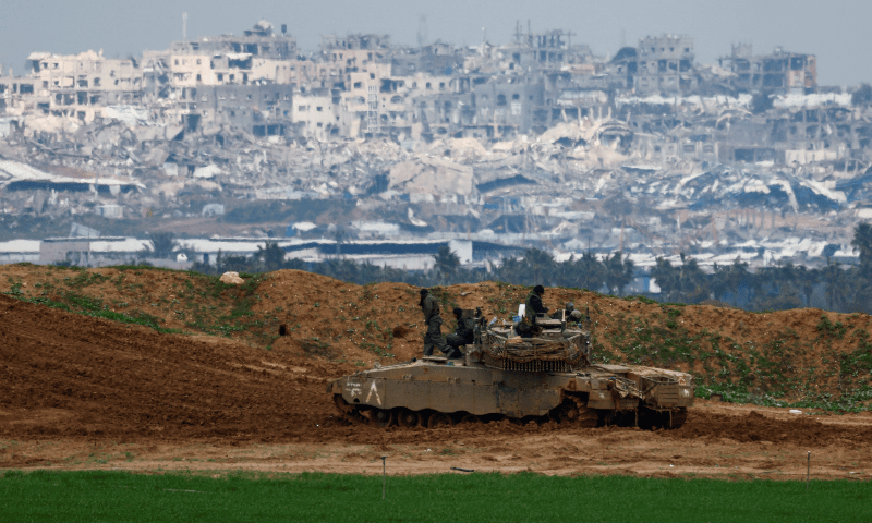  Israeli soldiers gather on top of a tank on the Israeli side of the border with Gaza, amid a ceasefire between Israel and Hamas, as seen from Israel on February 11, 2025. &mdash; Reuters/Amir Cohen 