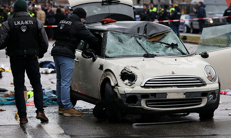 Police examine a car which drove into a crowd in Munich on February 13, injuring several people. — Reuters
