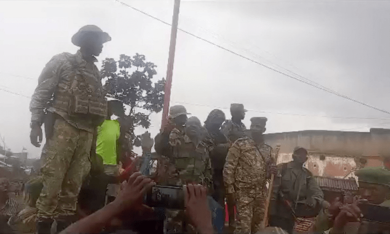 One of several people in military clothing speaks to a gathered crowd in Katana, near Kavumu airport, Democratic Republic of Congo, as Rwandan-backed M23 rebels have captured the town, according to an M23 source, a resident and a civil society leader, in this still image obtained from a social media video released on Feb 14, 2025. &mdash; Social media/via Reuters