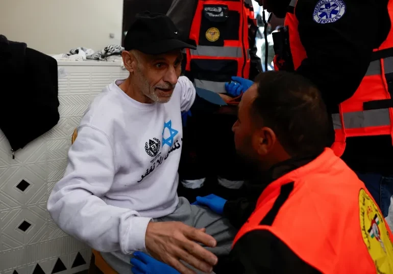 A medic aids a freed Palestinian prisoner in Ramallah, West Bank, after being released from an Israeli jail on February 15. — Reuters