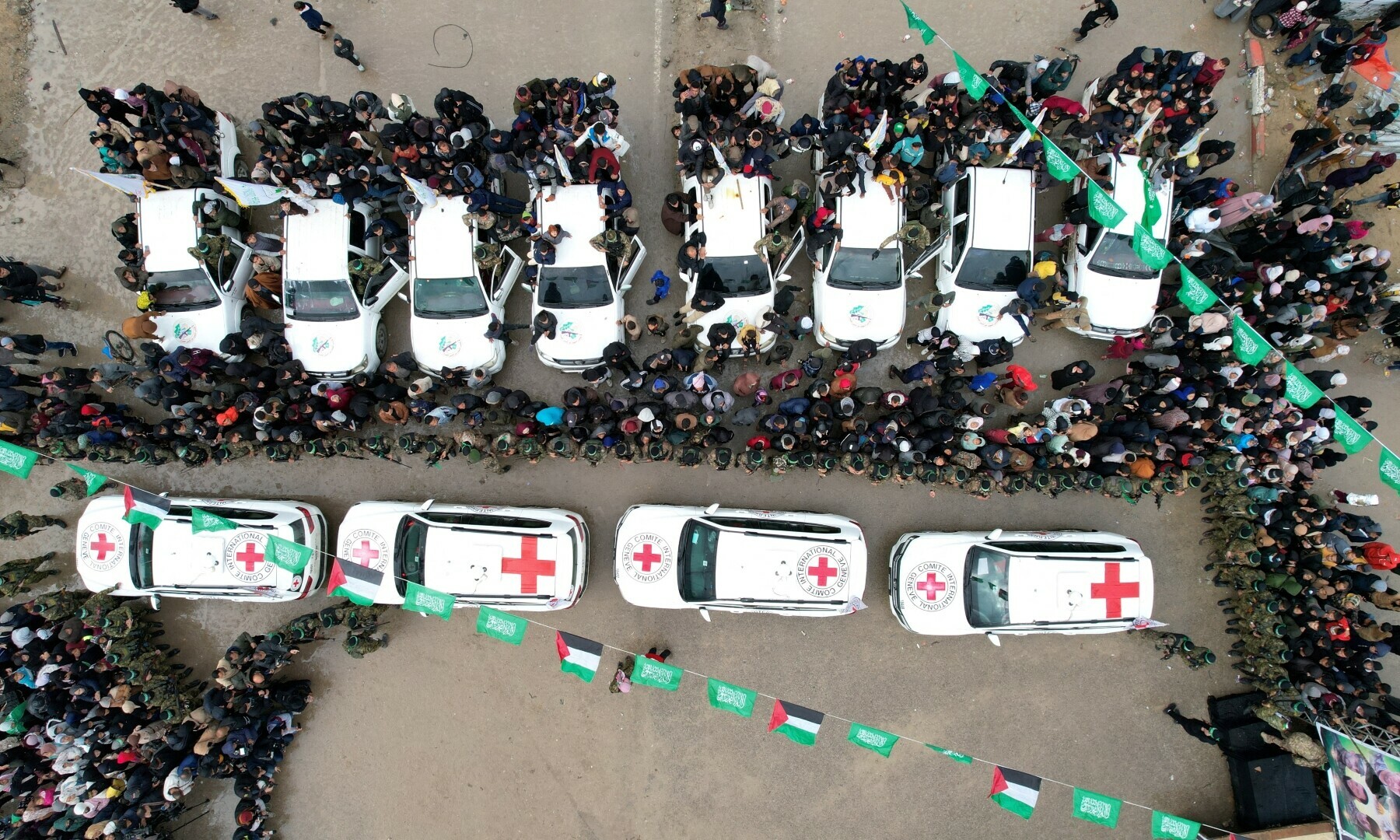 A drone view shows people and Palestinian Hamas militants gathering around International Committee of the Red Cross (ICRC) vehicles on the day Avera Mengistu and Tal Shoham are released by Hamas, in Rafah in the southern Gaza Strip on Feb 22, 2025. — Reuters