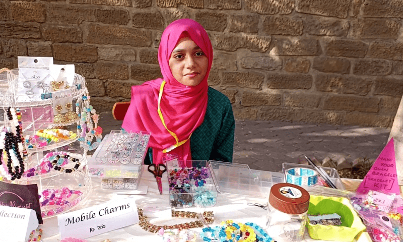 Maryam Hasan at the ‘Bliss Bracelets’ stall at the Children’s Market, organised by TDF MagnifiScience Centre, in Karachi on Saturday. — Photo by author