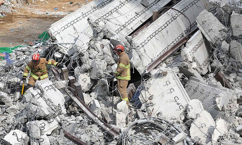 Rescuers search for missing workers after a bridge collapsed at an expressway construction site in Anseong on February 25. — AFP Rescuers search for missing workers after a bridge collapsed at an expressway construction site in Anseong on February 25. — AFP