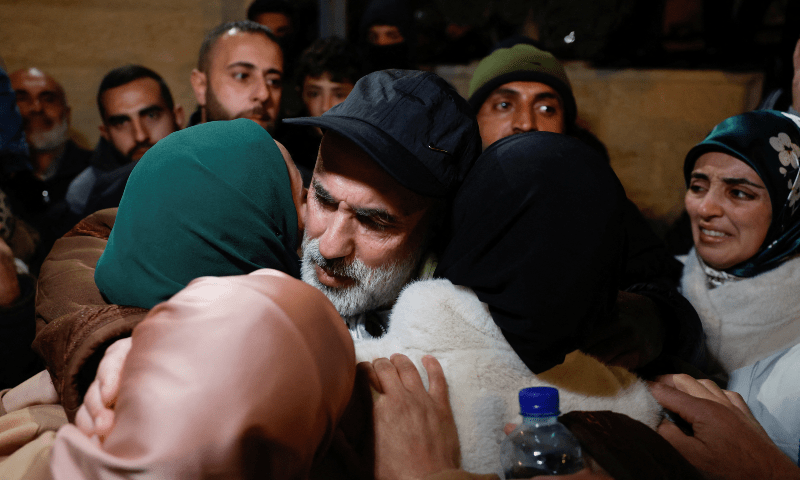  People embrace as Palestinian detainees arrive on a bus after they were released from an Israeli jail, in Ramallah in the Israeli-occupied West Bank, on Feb 27, 2025. &mdash; Reuters 