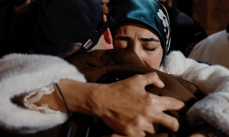  People embrace and react as Palestinian detainees arrive on a bus after they were released from an Israeli jail, in Ramallah in the Israeli-occupied West Bank, on Feb 27, 2025. &mdash; Reuters 
