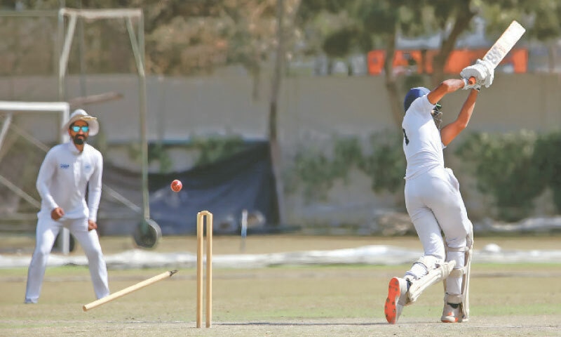 KARACHI: A Higher Education Commission batter is cleaned up during the President&rsquo;s Trophy match against the State Bank of Pakistan at the SBP Sports Complex on Saturday.&mdash;courtesy PCB